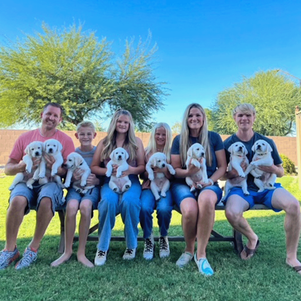 Picture of White Labrador Breeder in Arizona with family and puppies